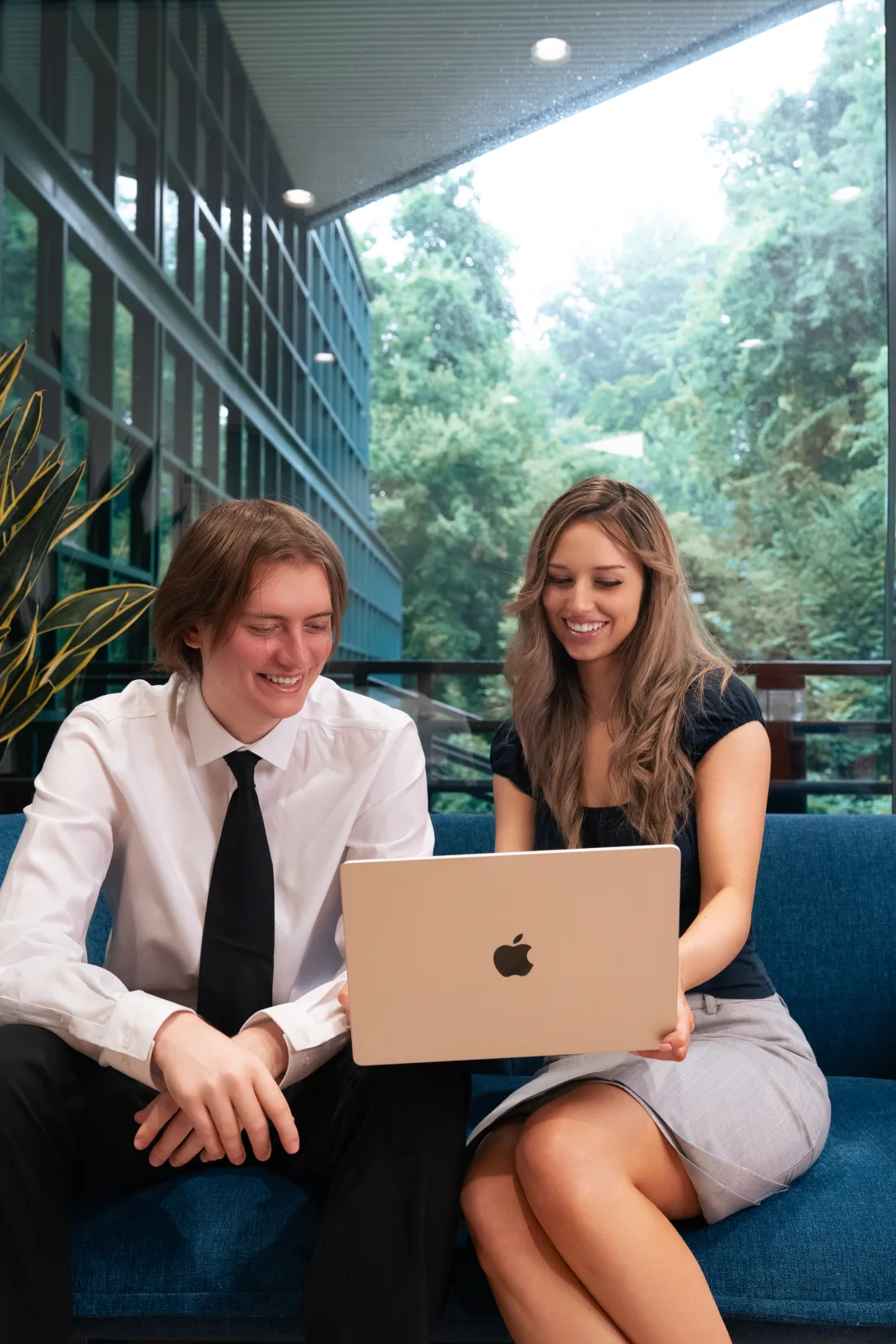 Grace Clark and Joe Tracy, Co-Founders of Snapfire Automation, reviewing work together on a laptop.